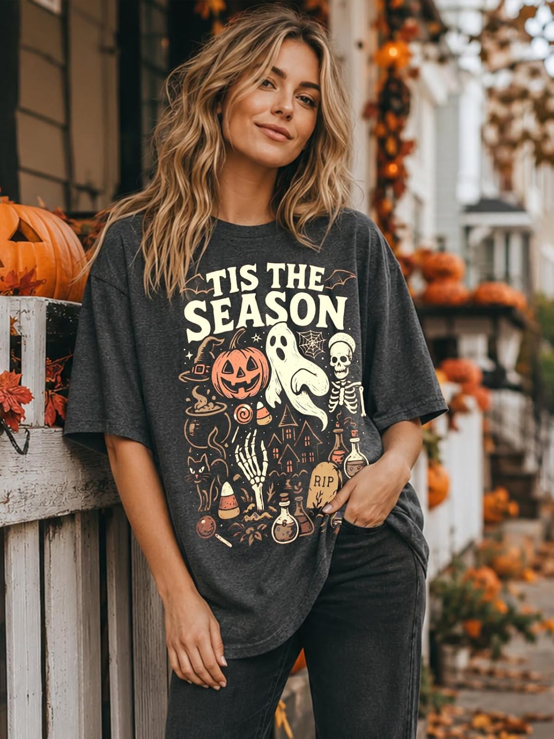 vintage-inspired multi-element graphic print featuring ghost, pumpkin, skeleton, witch hat, black cat, candy corn, potion bottles, and haunted house